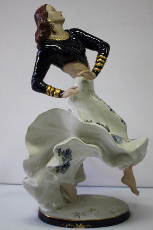 Large Royal Dux Porcelain Figure,: depicting Rita Hayworh dancing with a flowing dress, in tones of blue, white and gilt, on oval base, h 59cm