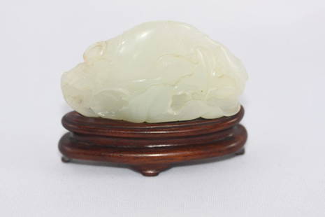 Good Chinese White Jade Carved Plaque,: carved in the form of a squirrel with fruit and flowers, on a hardwood stand, l 6.5cm