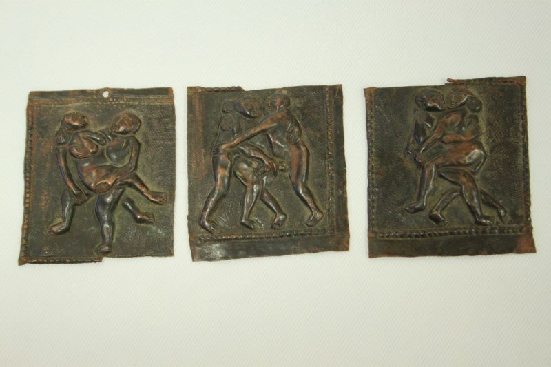 Three Nepalese 19th Century Tantric Plaques,: embossed copper figures in tantric poses, 7cm x 6xcm approx.