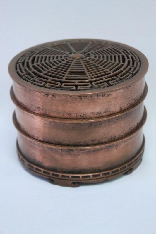 Chinese Copper Incense Clock,: of three sections, lid pierced with spider in web design, h 7.5cm,