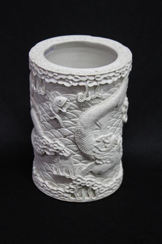 Chinese Blanc de Chine Brush Pot,: with high relief dragons and fish, impressed seal mark to base, h 15cm,
