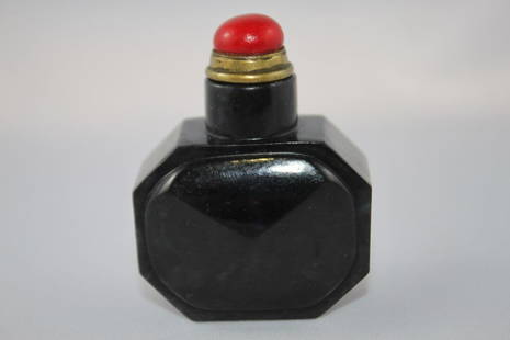 Chinese Black Nephrite Snuff Bottle and Stopper,: of octagonal section and faceted oval side panels, with coral stopper, h 6cm.