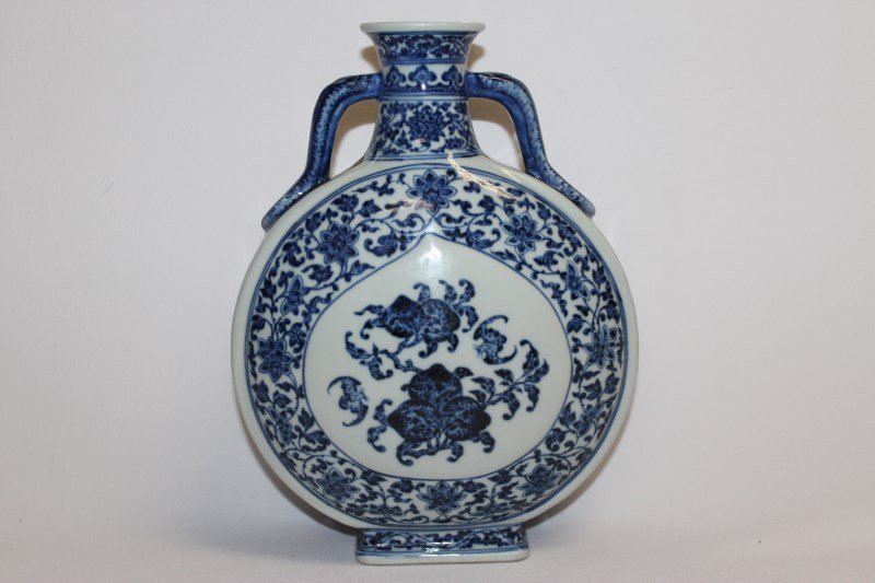 Chinese Porcelain Vase,: twin handled moon flask with blue and white arabesque floral decoration with two central panels decorated with flowers and bats, under glaze four character mark to base, h25.5cm,