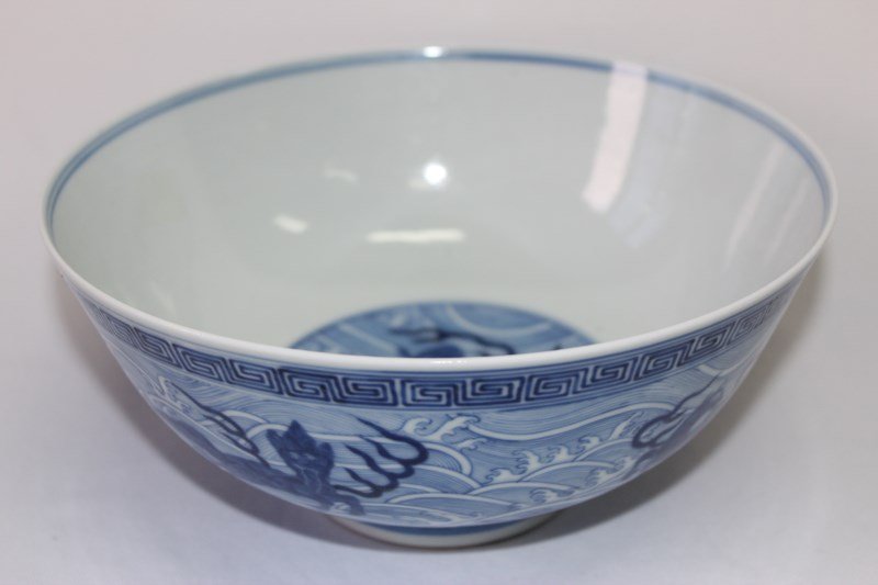 Chinese Blue and White Porcelain Bowl,: deep bowl on raised circular foot, interior decorated with Dragon, exterior with a multitude of mythological beasts frolicking in the waves, six character blue under glaze period mark to base, d 21cm,