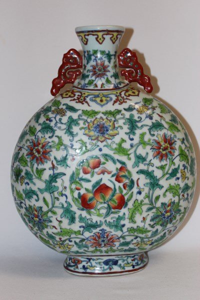 Chinese Famille Vert Moon Flask,: the neck flanked by stylised dragon handles, the body decorated with peaches, and scrolling peony and lotus flowers, on a oval foot, seal mark to base, h 33cm