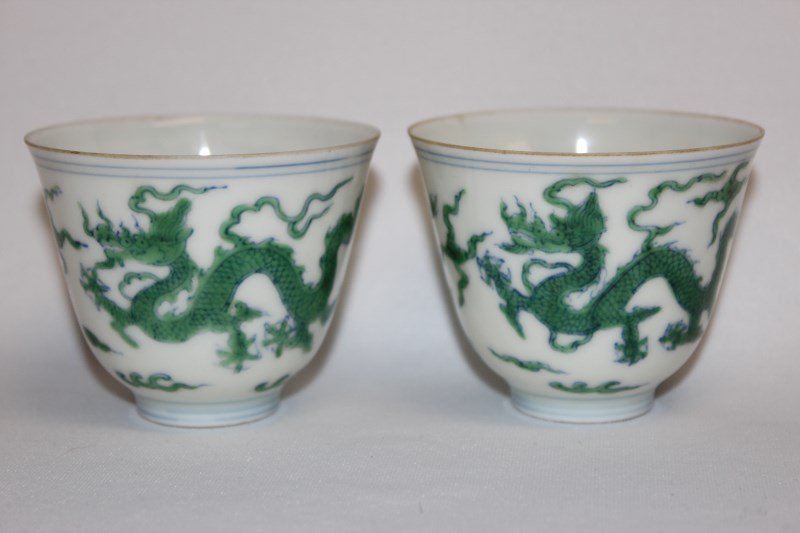 Pair of Chinese Porcelain Wine Cups,: of bell form, decorated with rampant dragons and flaming pearls, in tones of green and underglaze blue, six character mark to foot, h 5.5cm (2)