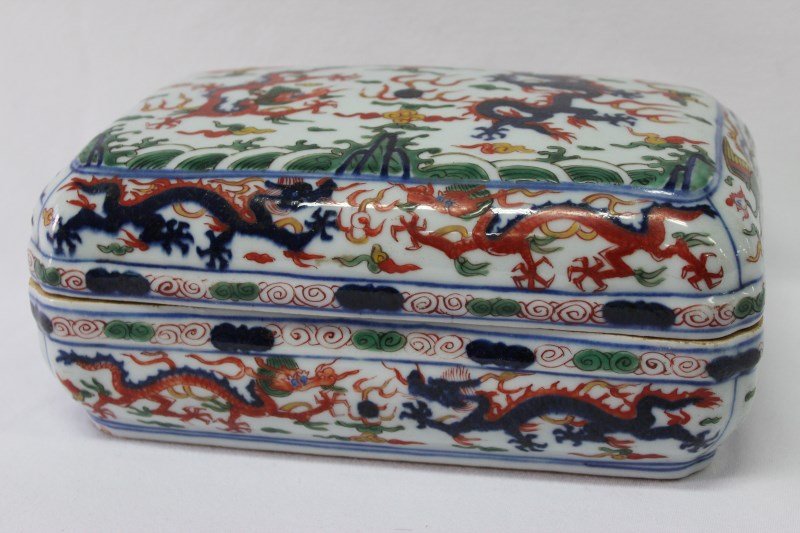 Chinese Porcelain Box and Cover,: of rectangular form, with famille verte decoration of various Dragons chasing pearls, with green waves beneath them. six character mark to base, l 24cm