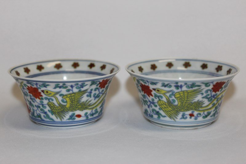 Pair of Chinese Flared Porcelain Bowls,: the interior decorated with the Buddhist wheel, the exterior decorated with phoenix, flowers and vines, in tones of green, red, and yellow, six character mark to base, h 4cm (2)