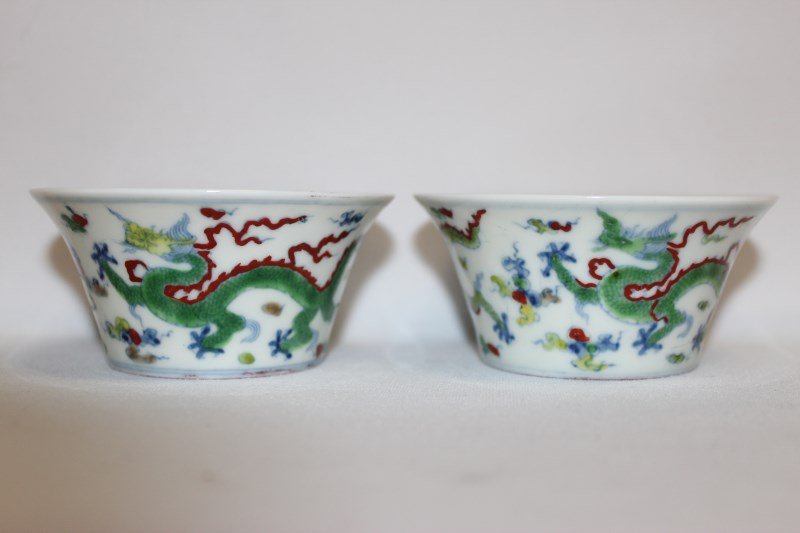 Pair of Chinese Doucai Porcelain Cups,: of flared form, decorated with dragons, flaming pearls and cloud scrolls, six character mark to base, d 9cm (2)