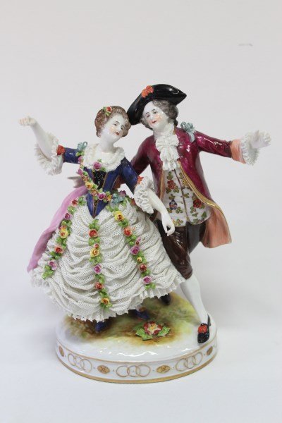 Volkstedt Porcelain Figure Group,: depicting a dancing couple, the lady with a lace and floral encrusted dress, on a naturalistic base, in tones of pink, maroon, blue and green, impressed 'Renard' and an underglaze blue factory mark, h