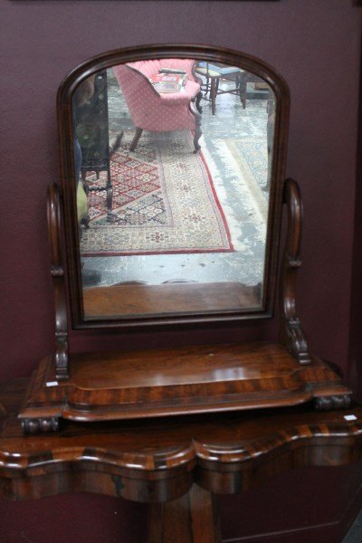 Victorian Flamed Mahogany Toilet Mirror,: with a rectangular mirror, flanked by scrolled supports, on a stepped rectangular base, with stylised paw feet, 84cm x 77cm