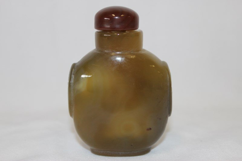 Chinese Carved Agate Snuff Bottle and Stopper,: of pilgrim flask form, with stylised twin ring handles carved to shoulders, h 8cm