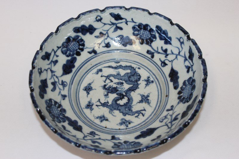 Chinese Blue and White Porcelain Bowl,: with crenellated rim and base, on a double ring foot, with blue and white decoration, interior with central coiling dragon in clouds surrounded by floral band, six blue underglaze character mark to ba