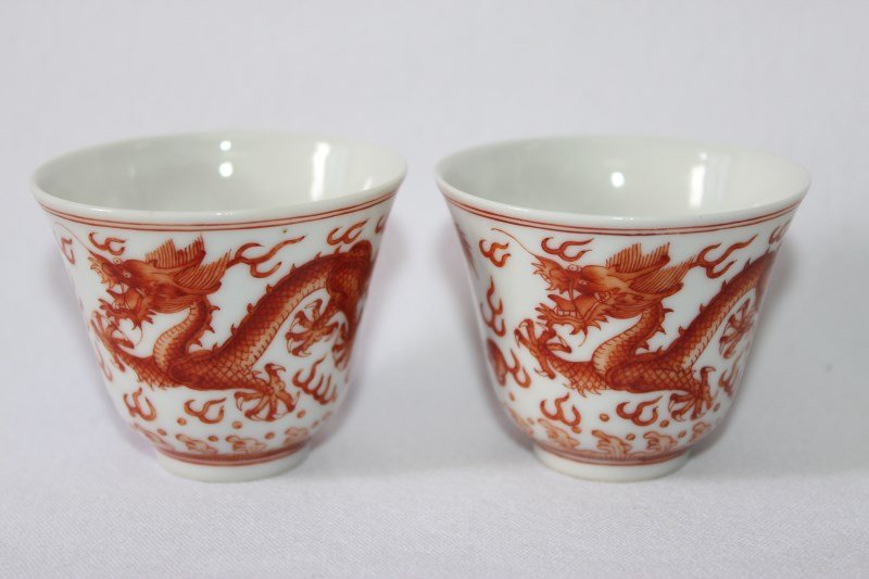 Pair of Chinese Porcelain Wine Cups,: of flared form, decorated with rampant dragons in orange and gilt, six character mark to base, (2)
