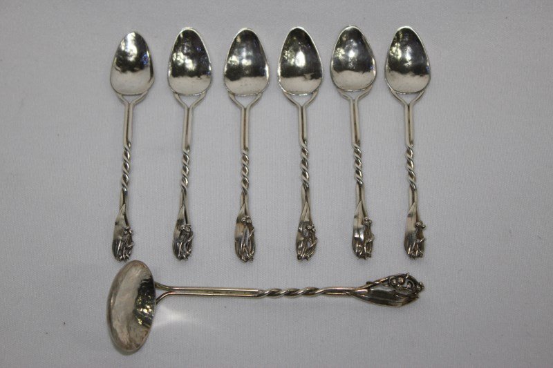 Set of Six Australian Silver Teaspoons By Mildred: Creed, together with sauce ladle, the handles of twist from terminating into a gum nut and leaf motif, total weight 60gms (6)