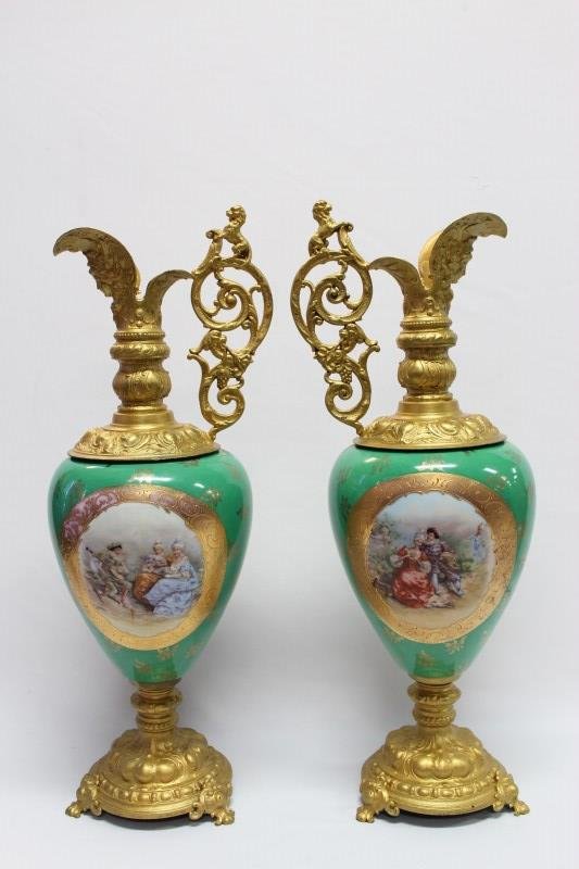 Monumental Pair of Porcelain and Ormolu Ewers,: with gilt baroque pourer's, handles and feet, porcelain body with green ground and central painted panels depicting courting couples, by Jean-Baptiste Stahl, h 58cm (2)