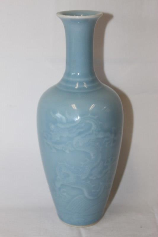 Chinese Porcelain Vase,: willow leaf shape vase with carved decoration on Dragons among waves under a pale blue monochrome glaze, with six character seal mark to base, h 24.5cm
