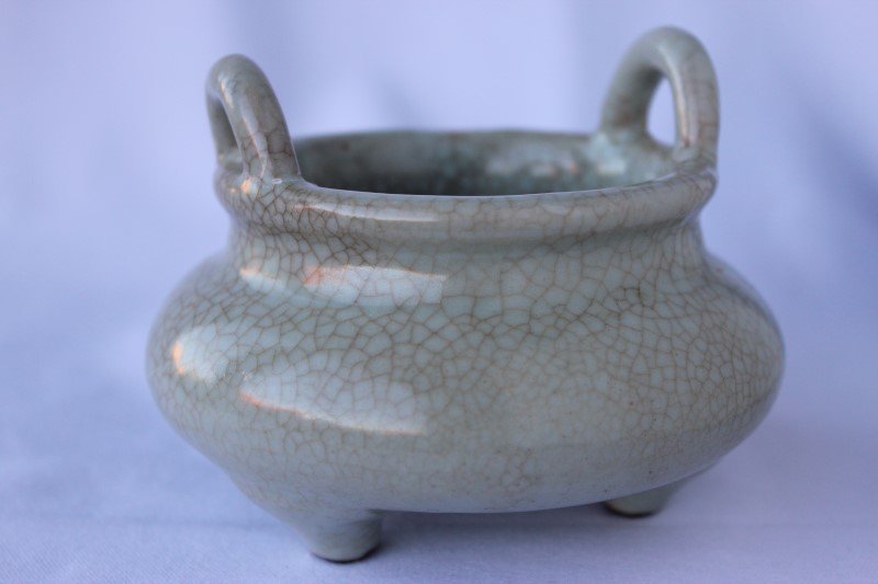 Chinese Pottery Censer,: bun form with twin lug handles and raised on three legs, celadon glazed with blue four character mark, h 8.5cm