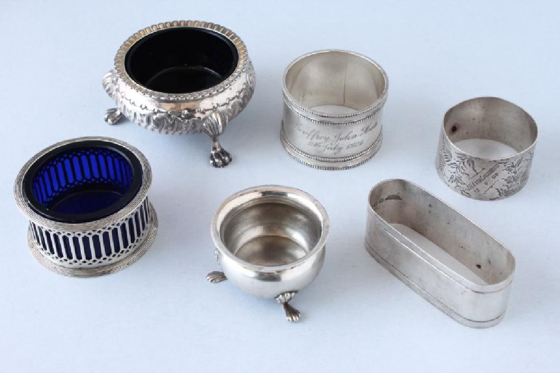 Three Sterling Silver Salts and Three Napkin Rings: Salts: the first hallmarked Chester, 1911, (?) Nathan and Hayes, pierced spool shaped with blue glass liner, weight 35 gms, d 6 cm; the second hallmarked London, 1883, Robert Harper, embossed cauldron