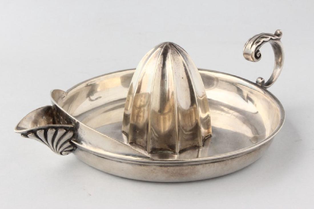Rare Edwardian Sterling Silver Lemon Juicer,: hallmarked, Edinburgh, 1904, H.J, with a scroll handle with acanthus handle and anthemion spout, total weight 243gm