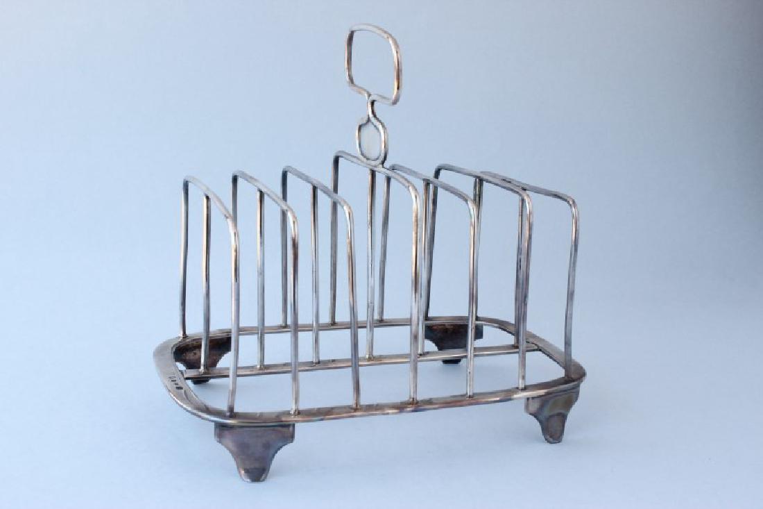 Rare George III York Hallmarked Sterling Silver: Toast Rack, hallmarked York, 1815, Edward Jackson, (no town mark), a six slice toast rack, rectangular arched wire divisions each with central strut, on a base frame on four panel feet, with a central