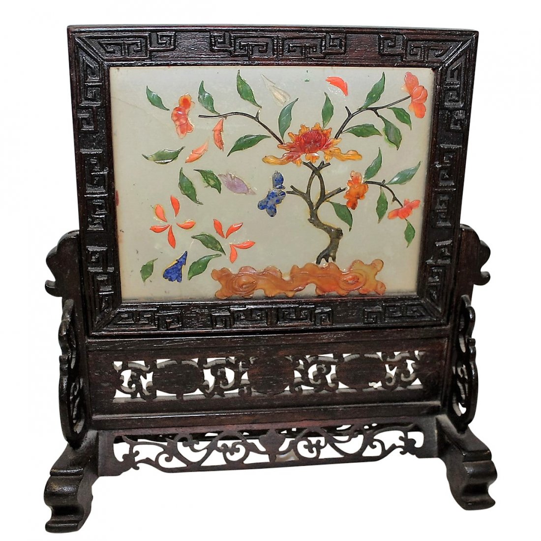 Asian Multi-colored Table Screen: Miniature Asian table screen. Carved wood frame. Multi-colored hardstone insert with coral and jade. Insert depicts blossoms.