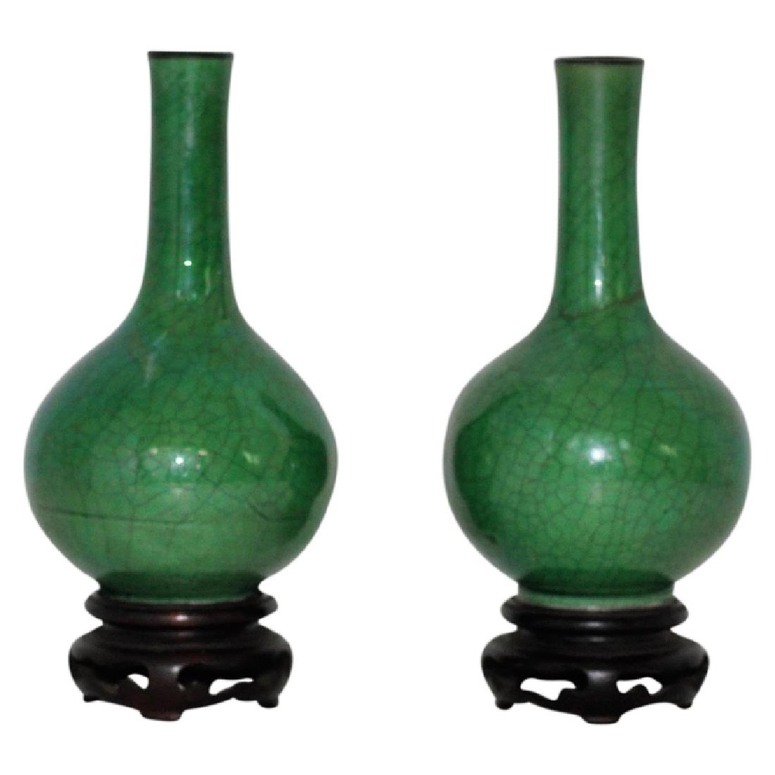 Pair of Quing Dynasty Vases: Set of 2 Quing Dynasty crackle vases, on hand fitted hardwood base stands. Green apple in color. Chinese origins. Measures 7.25" High with the stand and 3.25" Wide. 1 vase has no damage and the other 