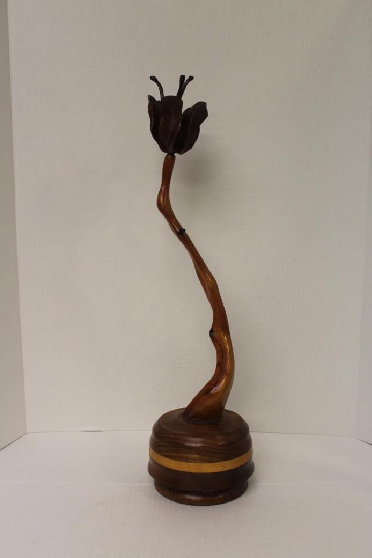 "Adiron Dack Rose" Wood Carved Music Box: Wood carving of a flower with the base featuring a music box. This wood carving is titled "Adiron Dack Rose" by George Wells. New York origins. Measures approximately 20.5" High and 5.25" Wide at the 