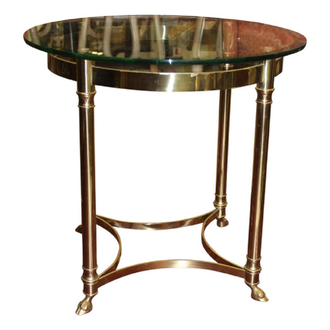 La Barge End Table: Mid Century Modern/Holly Regency end table by La Barge. This piece features brass frame with green edged glass top and hoof feet. Measures approximately 22.25" High and 24" in diameter top. Very good