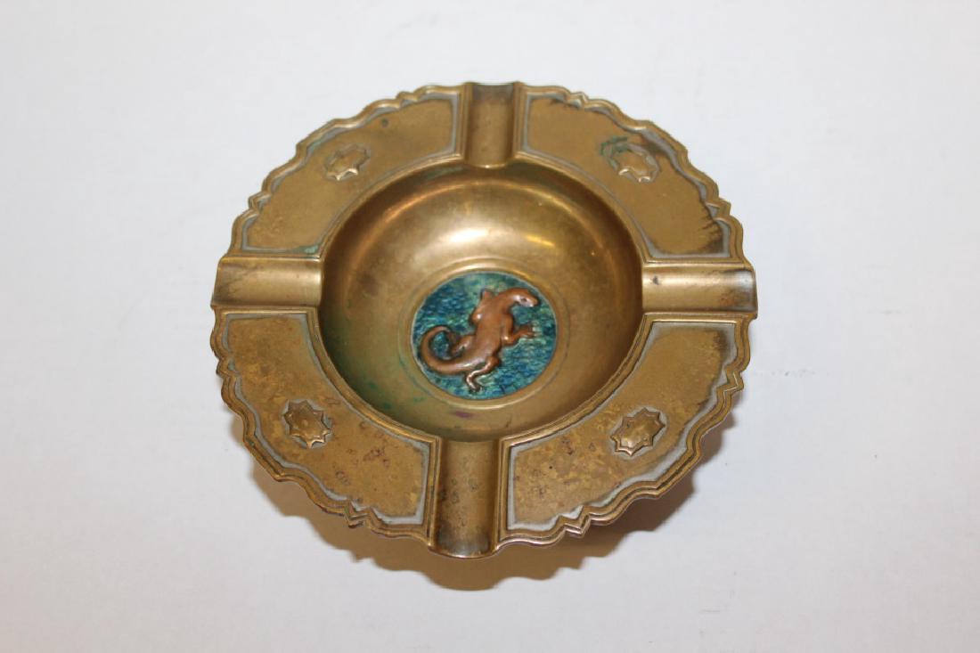 Oscar Bach Deco Ashtray: Deco style ashtray by Oscar Bach. Teal/blue elipse in the center of the ashtray with a bronze lizzard. Made on bronze. Signed on the bottom. Measures approximately 6.75" in diameter and 2.5" High. Ver