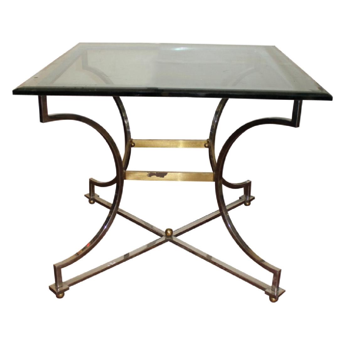 Silver and Gold Frame Double Bevel Glass Top Table: Glass top table featuring a silver and gold frame. The glass top features a double beveled edge. Measures approximately 29" High and 34.25" Wide. Good condition with no chips to the glass top and the 