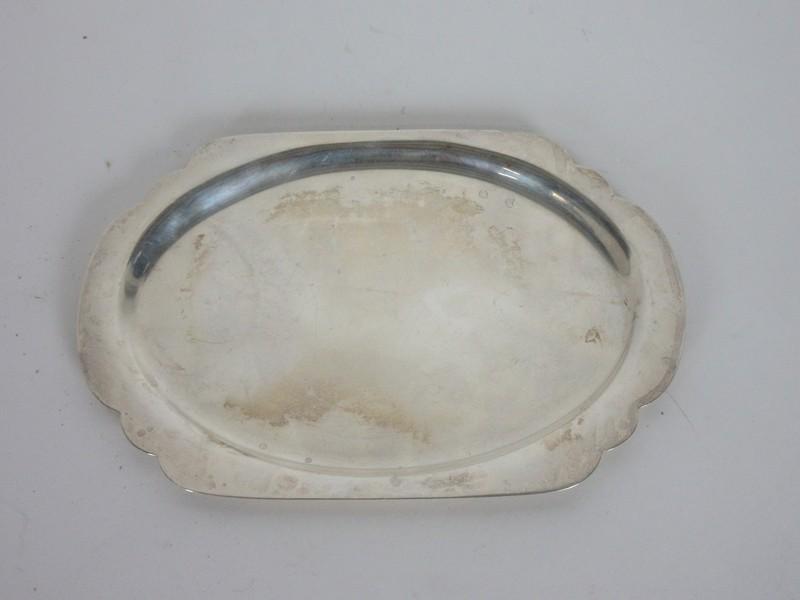 CARTIER STERLING SILVER SMALL TRAY: Fine small platter tray by Cartier. Measuring 7.5 x 5 inches. weighing 162 grams. Marked Cartier Sterling 925-1000 05591 Hand Made. Half moon indentation of one sise of the surface measuring 2.5 inche