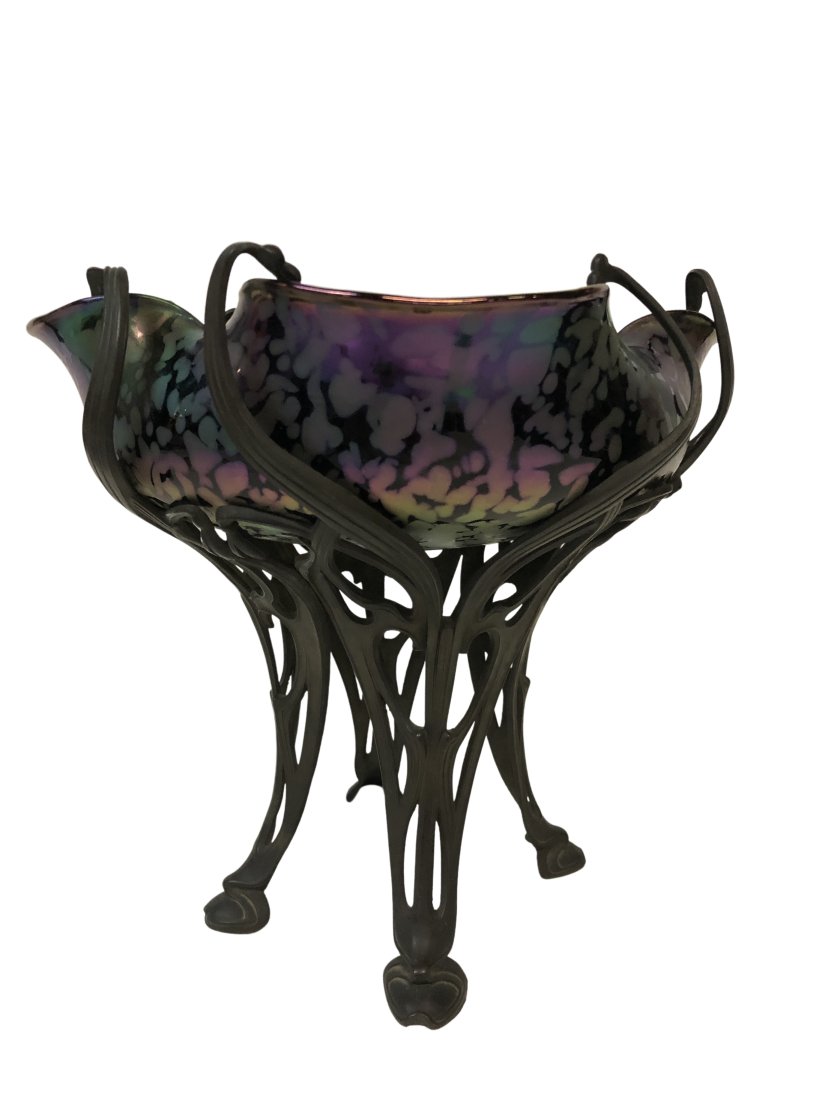 Loetz Style Glass Centerpiece Bowl in Bronze Stand: Loetz Style Glass Centerpiece Bowl in Bronze Stand. Ruffled & Crimped style art glass in deep purples. Austria Circa 1890. Unsigned Dimensions: 9 inches high x 9.25 inches wide. Top glass opening meas