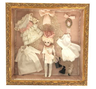 Bru Doll Reproduction in Glass Vignette Display Case: Bru Doll- reproduction in glass vignette style case with clothes and accessories. Nicely put together doll display. These Dolls come from a local estate. Her collection spans over 50 years and dolls f