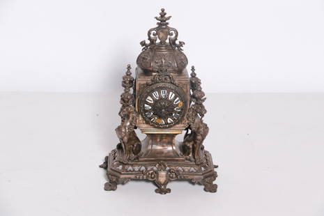 Tiffany & Company Clock: Gothic Style with griffins & shield. Porcelain Roman numerals on face. Tiffany & Company signed on works and case. 16.5" high x 11.75 wide x 6.5" deep. Magnificent piece!