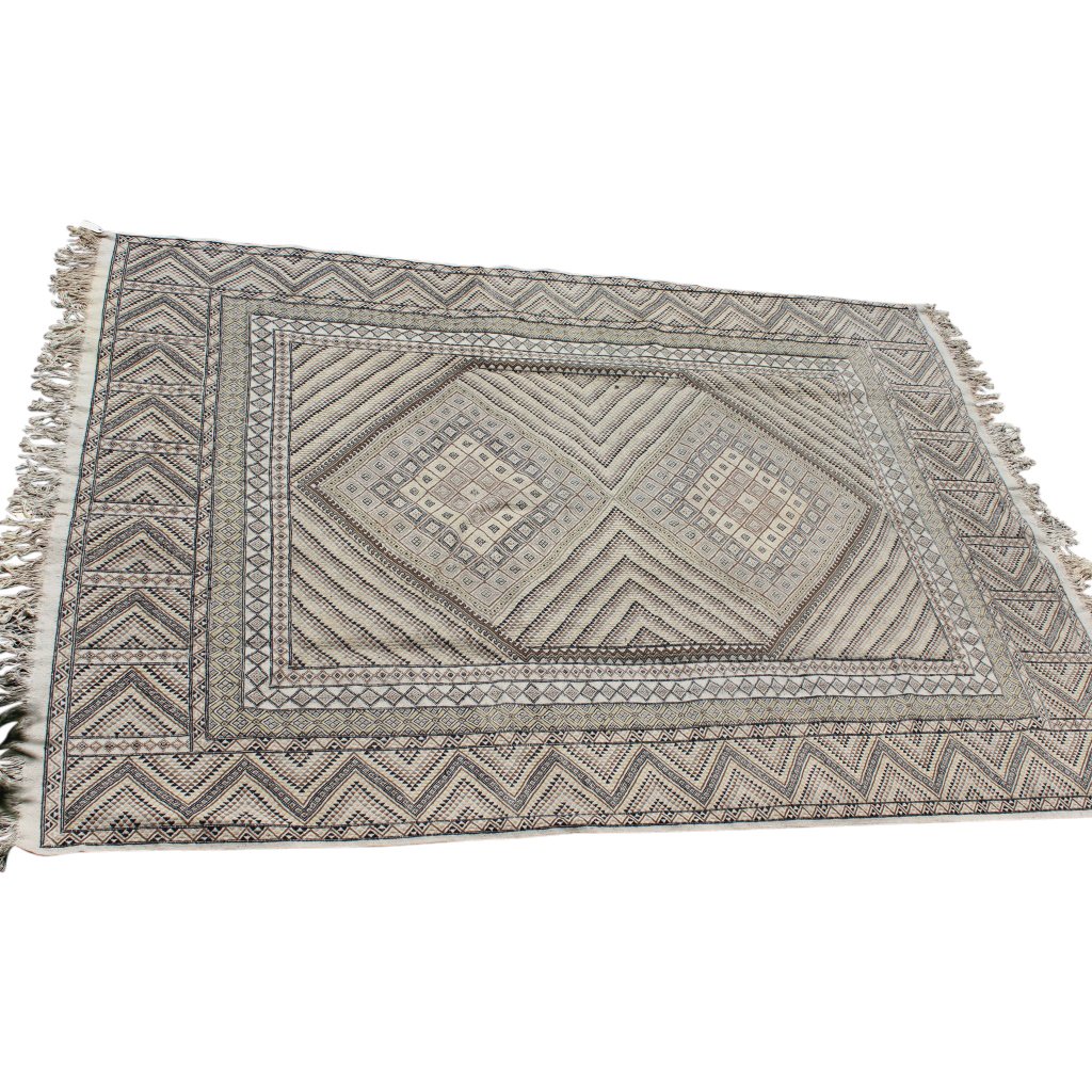 Tunisia Kilim Rug: Zig zag pattern in a versitile neutral pallette of tans, whites and browns. Measures 8'3" x 11"2". In very good condition with very little wear consistent with history.