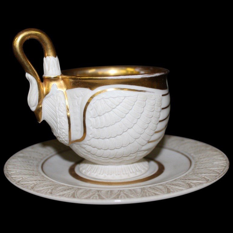 RPM Swan Cup and Saucer: Exquisite swan form cup and saucer in ivory gilt gold finish. Cup measures 4"h x 4"w x 2"d; saucer measures 6.25"diam. In very good condition with minimal wear consistent with history.