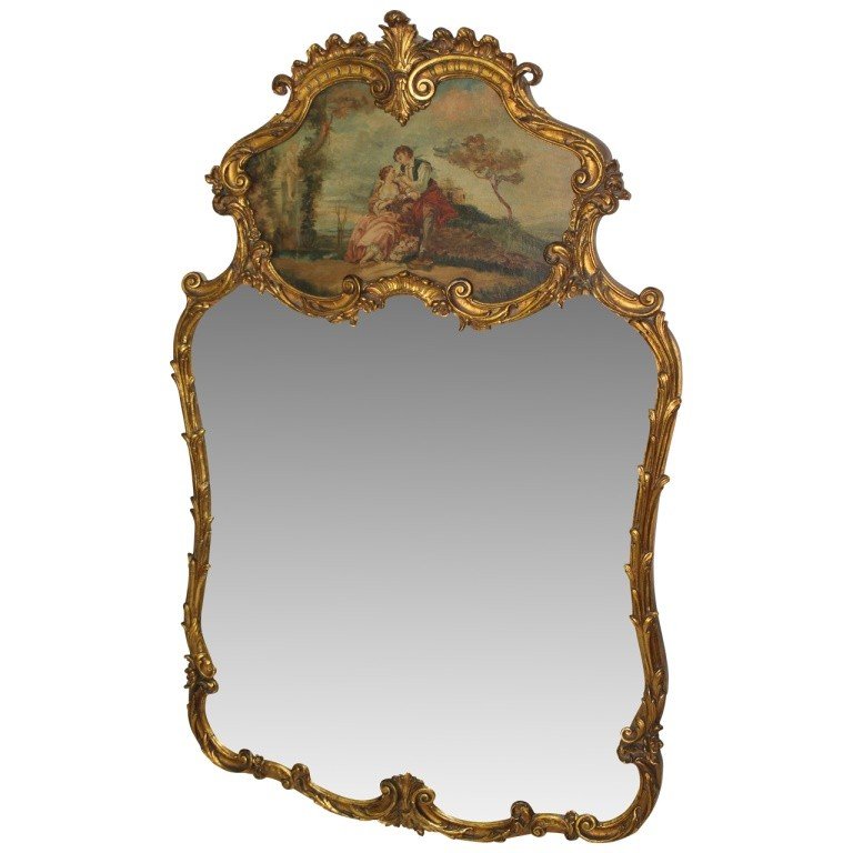 Victorian Mirror with Painted Scene: Lovely Verne Martin style paint on board of a man and woman adorns this ornate gilded pine mirror. Measures 47"h x 29"w x 2"d. Circa 1920's, France. In very good condition with piece of mirror frame m