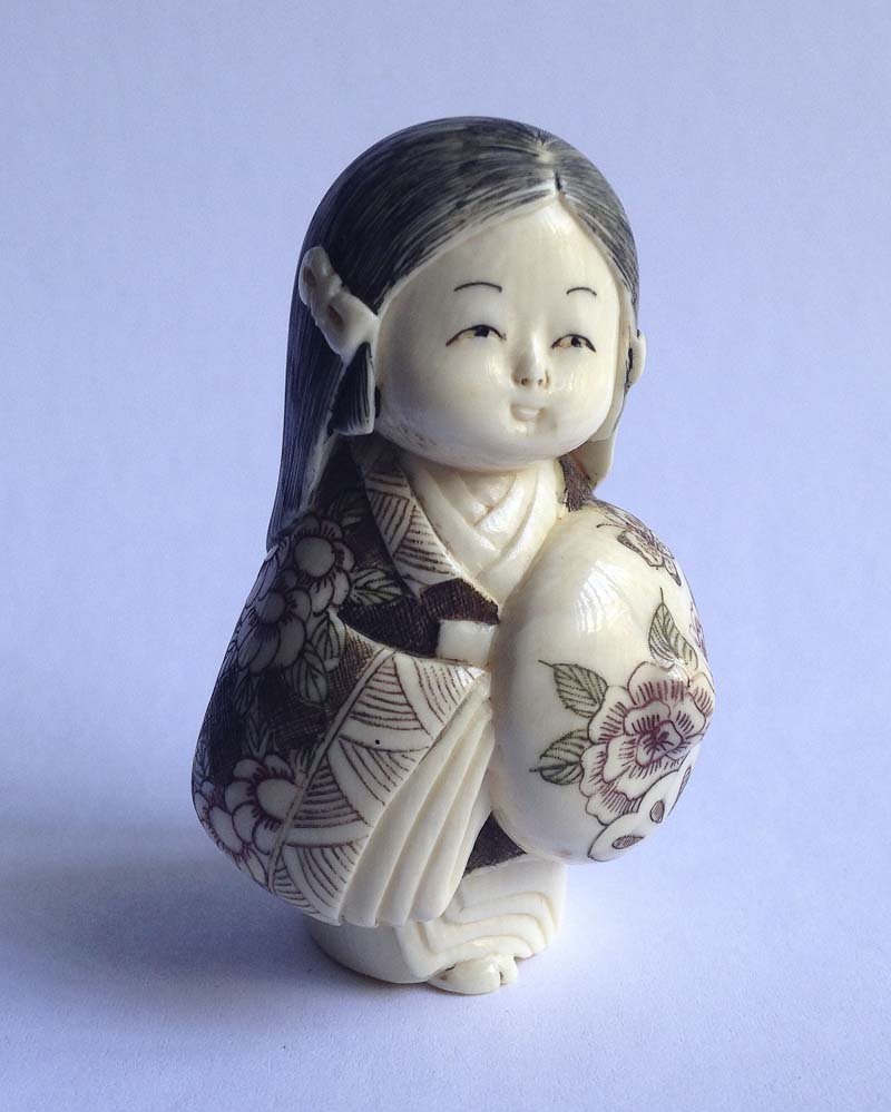 Japon, debut XXe. Netsuke Fillette au kimono: Japon, debut XXe Netsuke Fillette au kimono Ivoire sculpte, teinte dans les creux et signe Haut. 5,5 cm.