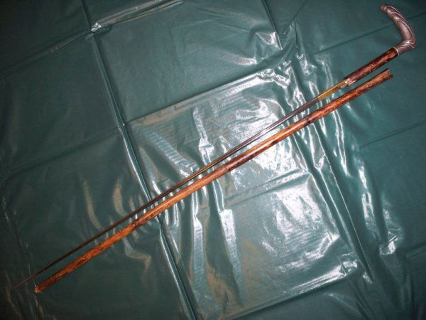 German WW1 walking cane: German WW1 walking cane with hiding sword, silver handle with silver kontent and German maker marks. Blade signed "Toledo".