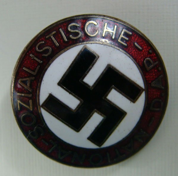 German N.S.D.A.P. member party badge: German N.S.D.A.P. member's enameled lapel badge. Pin-back. Marked "RZM" and M1/129.
