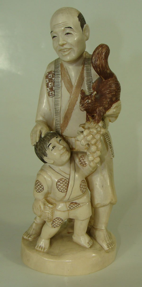 Japanese Carved Ivory Okimono Figure: Japanese Carved Ivory Okimono. Figure of Man with the squirrel on his shoulder and a child. Height - 7".