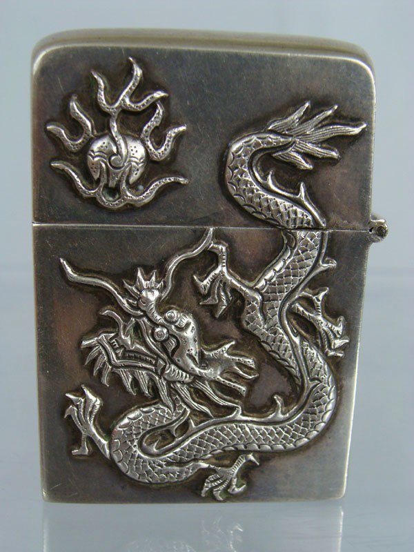Antique Chinese Zippo Lighter in Sterling Case: Antique Chinese Zippo Lighter in Sterling Case. Dragon Design. Marked on the bottom. Dimension: 2 1/4" x 1 1/2".