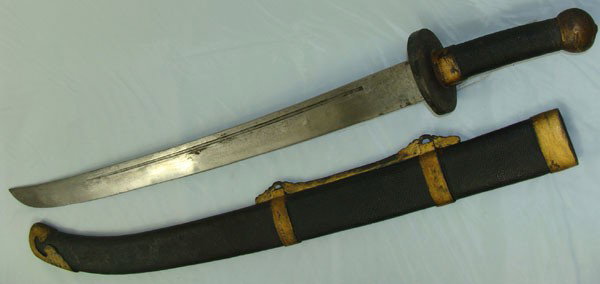 Large 19th Century Chinese Sword: Large Chinese Sword which dates from the third to fourth quarter of 19th Century. Single Edged blade with the fuller from each side. The hilt wears a simple brass guard, a wrapped wooden hilt with a s