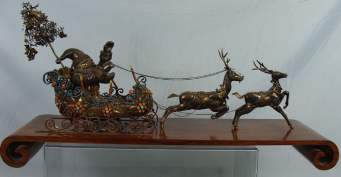 Chinese Export Silver Santa Claus in Sleigh: Chinese Export Silver Santa Claus in Sleigh with two Reindeers. Ornate cloisonne with the gemstones. ON the wooden stand. Early 20th Century. Total weight 2400 grams. Total length 24". Width 12".