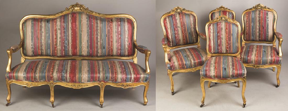 French Carved Gilt Wood Settee, Two Arm Chairs and Two: French Carved Gilt Wood Settee, Two Arm Chairs and Two Side Chairs. Late 19th century. French Carved Gilt Wood Settee; some loss to gilding on lower left, some wear to edges, otherwise very good; Ht.