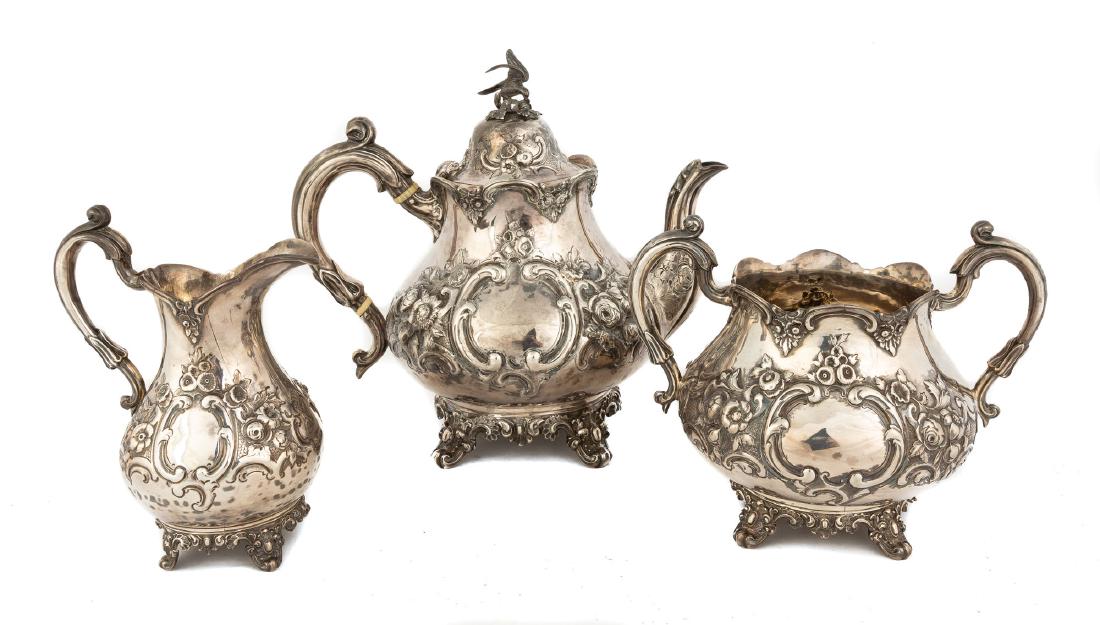 Three Piece English Silver Tea Set: By Robert Harper, London, 1865. 19th century with repoussé work and bird finial. 45.9 ozt. Max H 9" .