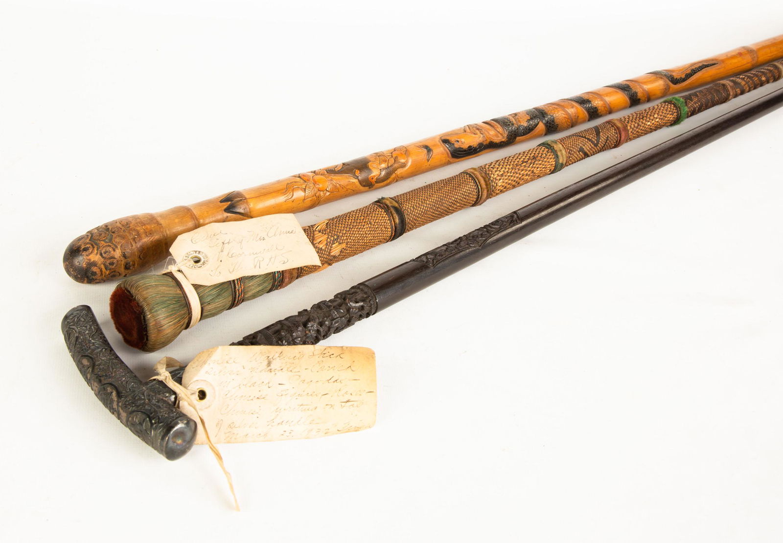 Three Walking Sticks Circa 1900. One in Asian motif: Three Walking Sticks Circa 1900. One in Asian motif with silver handle, carved pagodas and roses; one carved bamboo with snake and monkey-separation to cane; one caned texture. Max L 36" Rochester His