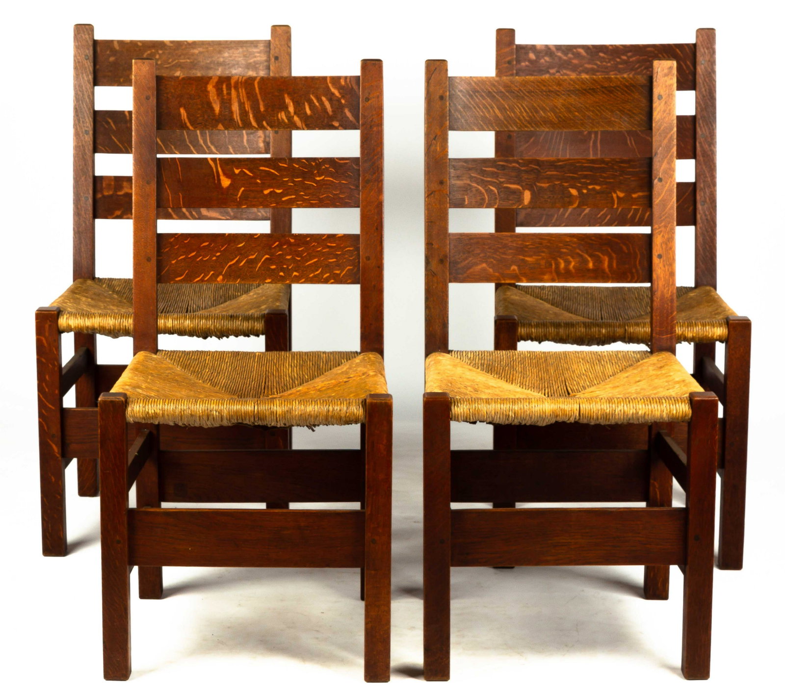 Set of Four Gustav Stickley Dining Chairs: Set of Four Gustav Stickley Dining Chairs Quarter sawn oak, old finish, possibly original. Red decal mark. Seat Ht 19" Chair Ht 37 1/2"
