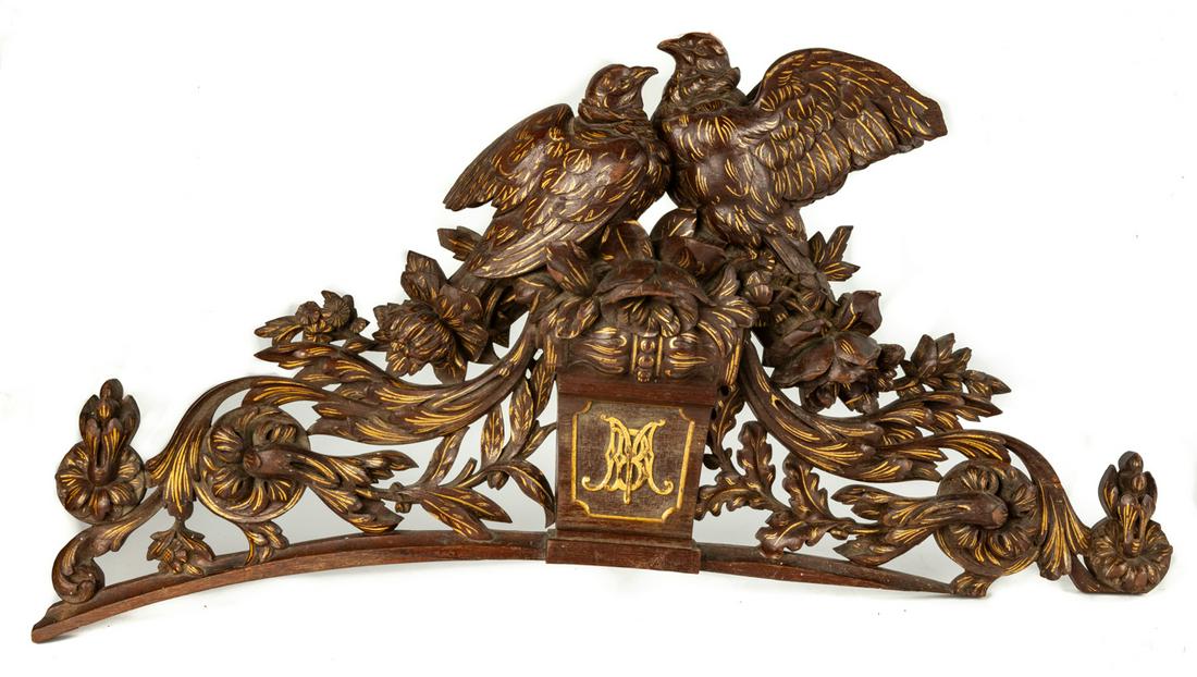 Carved Linden Crest: Carved Linden Crest circa 1872. With foliage, flowers, tree top, and birds with wings outstretched. Center panel "BM" gilted. Ht. 16 W 35 in. The collection of Joseph & Betty Ann Zyla, Clinton, New Yo